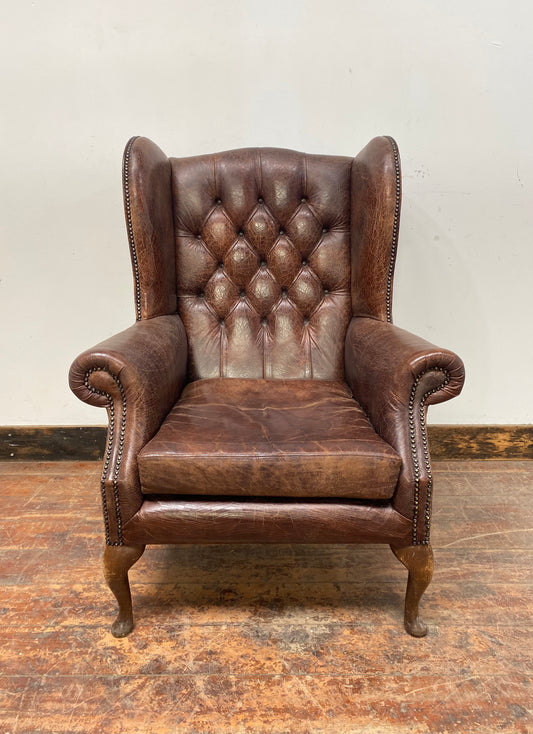Wingback armchair in brown leather