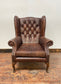 Wingback armchair in brown leather
