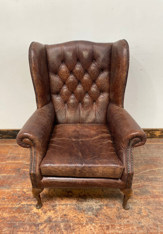 Wingback armchair in brown leather