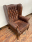 Wingback armchair in brown leather