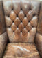 Wingback armchair in brown leather