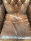 Wingback armchair in brown leather