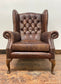 Wingback armchair in brown leather