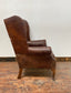 Wingback armchair in brown leather