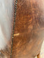 Wingback armchair in brown leather