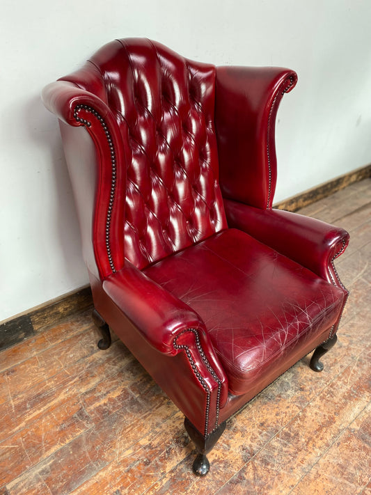 Chesterfield-style red leather wingback armchair
