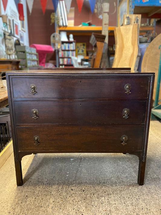Small vintage chest of drawers in dark wood