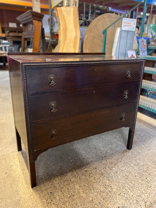 Small vintage chest of drawers in dark wood