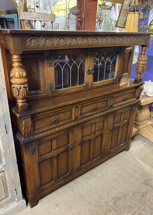 Antique solid oak tall sideboard / cabinet with ornate carvings