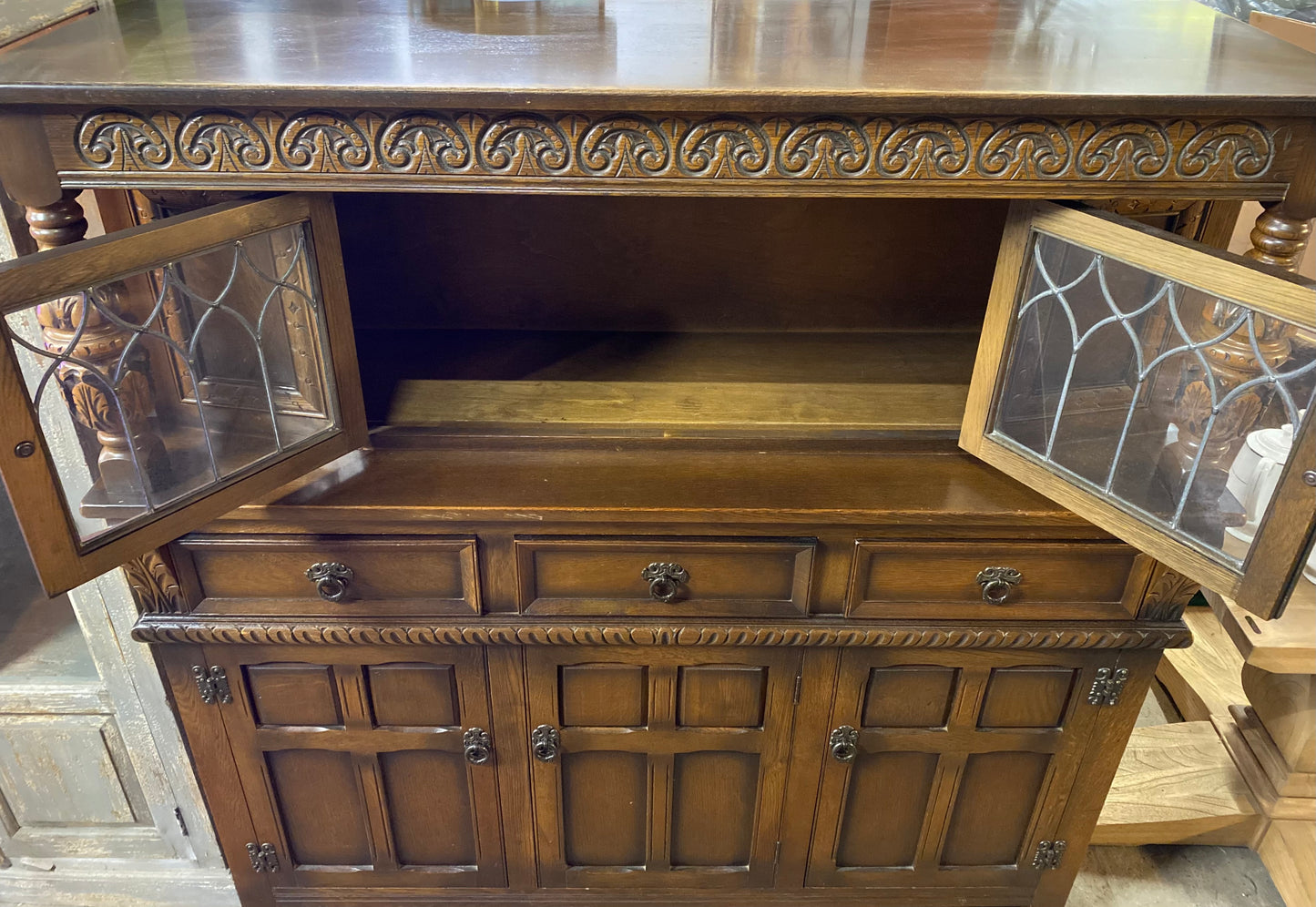 Antique solid oak tall sideboard / cabinet with ornate carvings