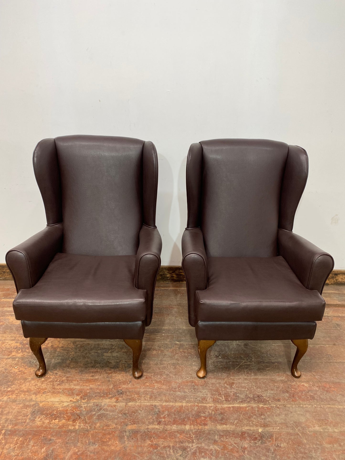 Pair of brown wingback armchairs