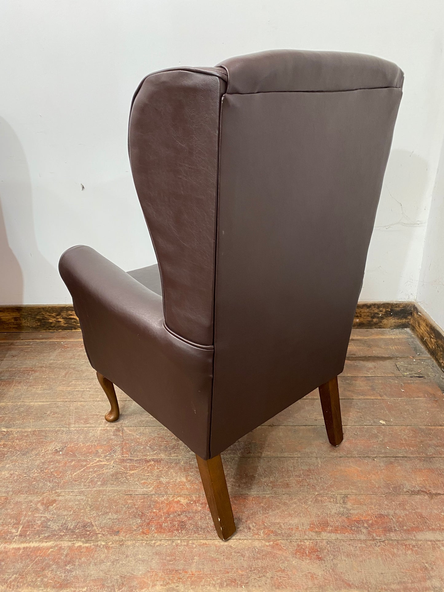 Pair of brown wingback armchairs