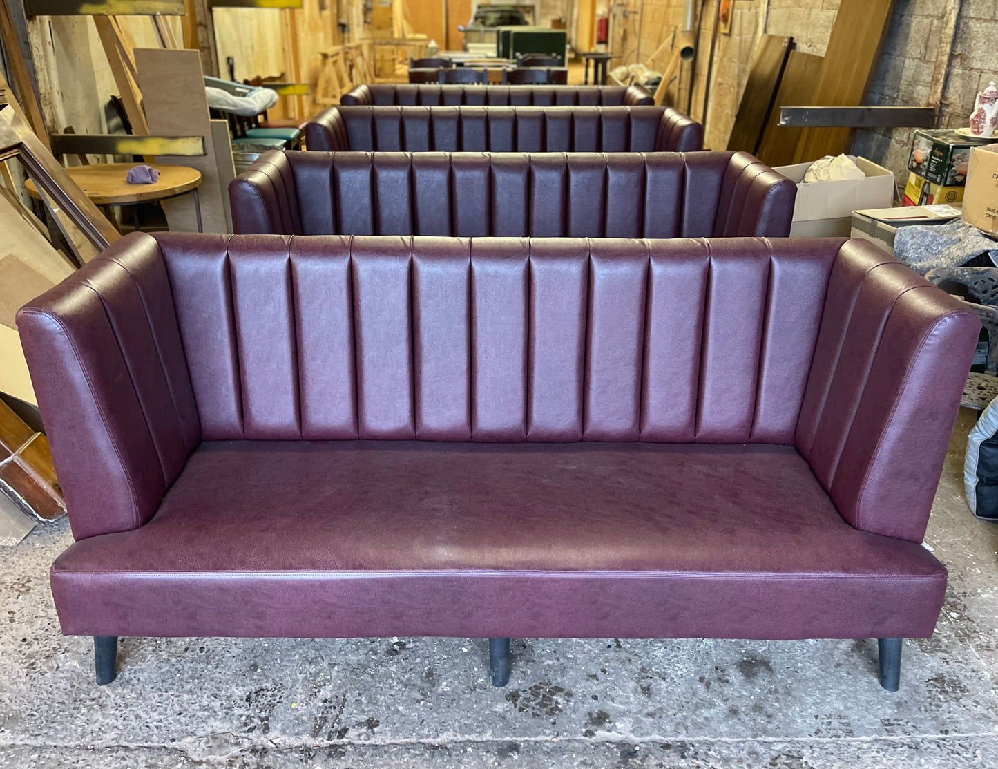 Long burgundy pub / bar / cafe bench in faux-leather