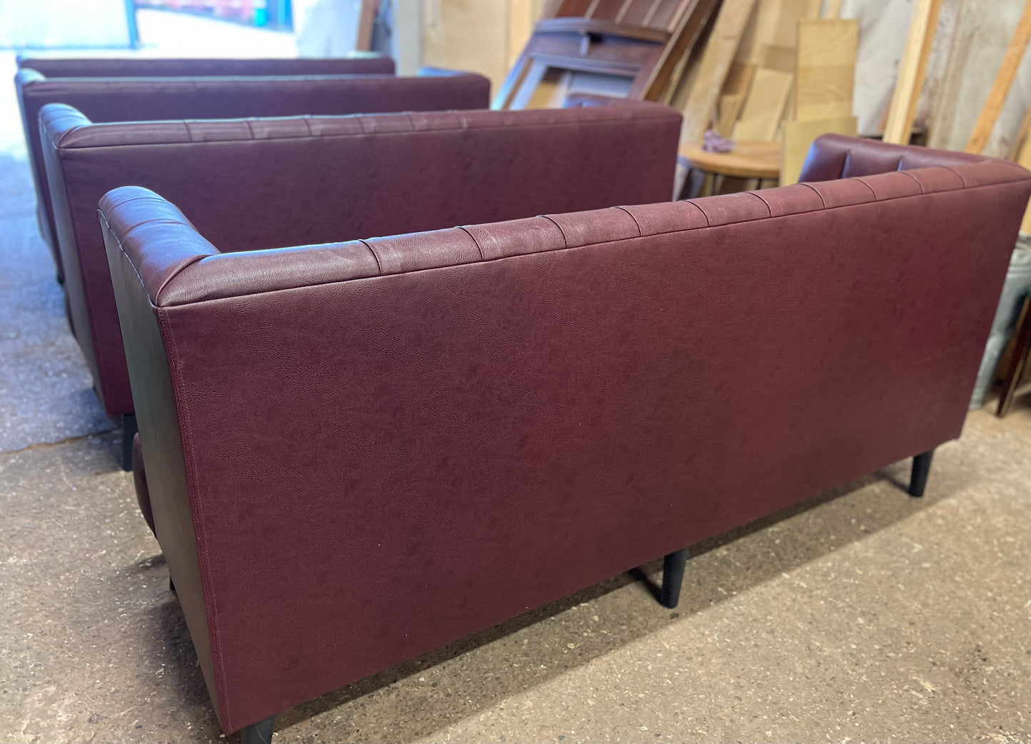 Long burgundy pub / bar / cafe bench in faux-leather