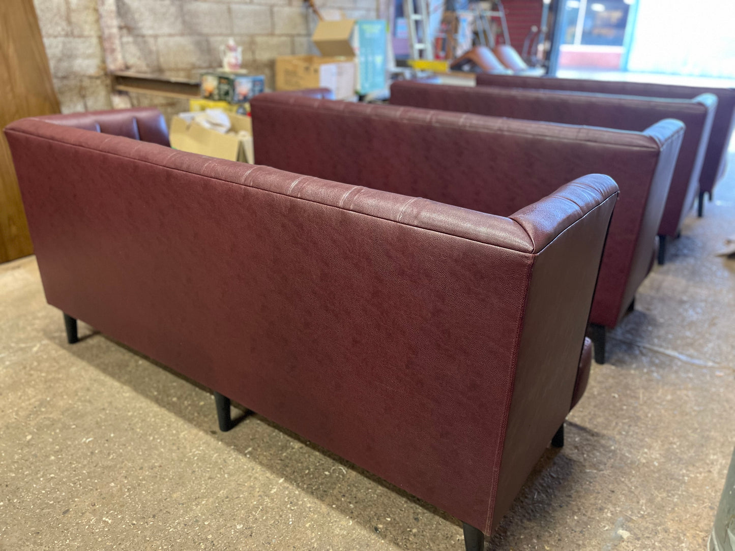 Long burgundy pub / bar / cafe bench in faux-leather
