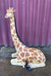 Small sitting giraffe figure / statue suitable indoors or outdoors