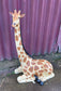 Small sitting giraffe figure / statue suitable indoors or outdoors