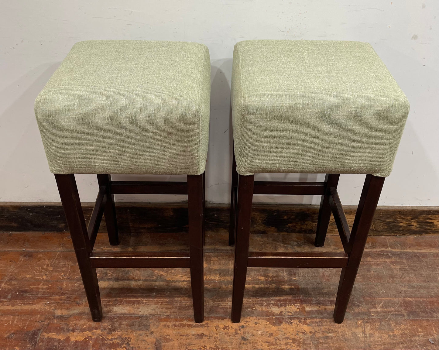 Pair of matching bar stools with light fabric seats
