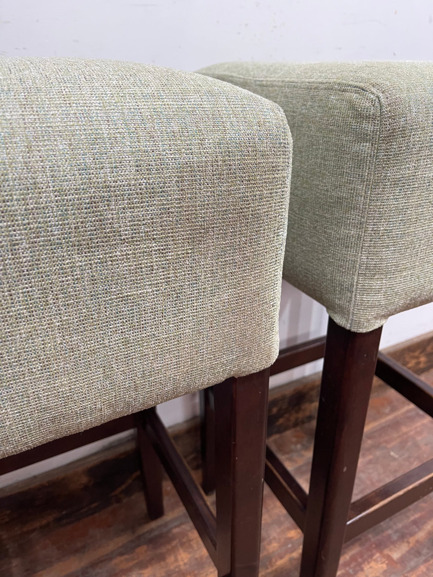 Pair of matching bar stools with light fabric seats