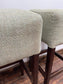 Pair of matching bar stools with light fabric seats
