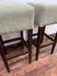 Pair of matching bar stools with light fabric seats