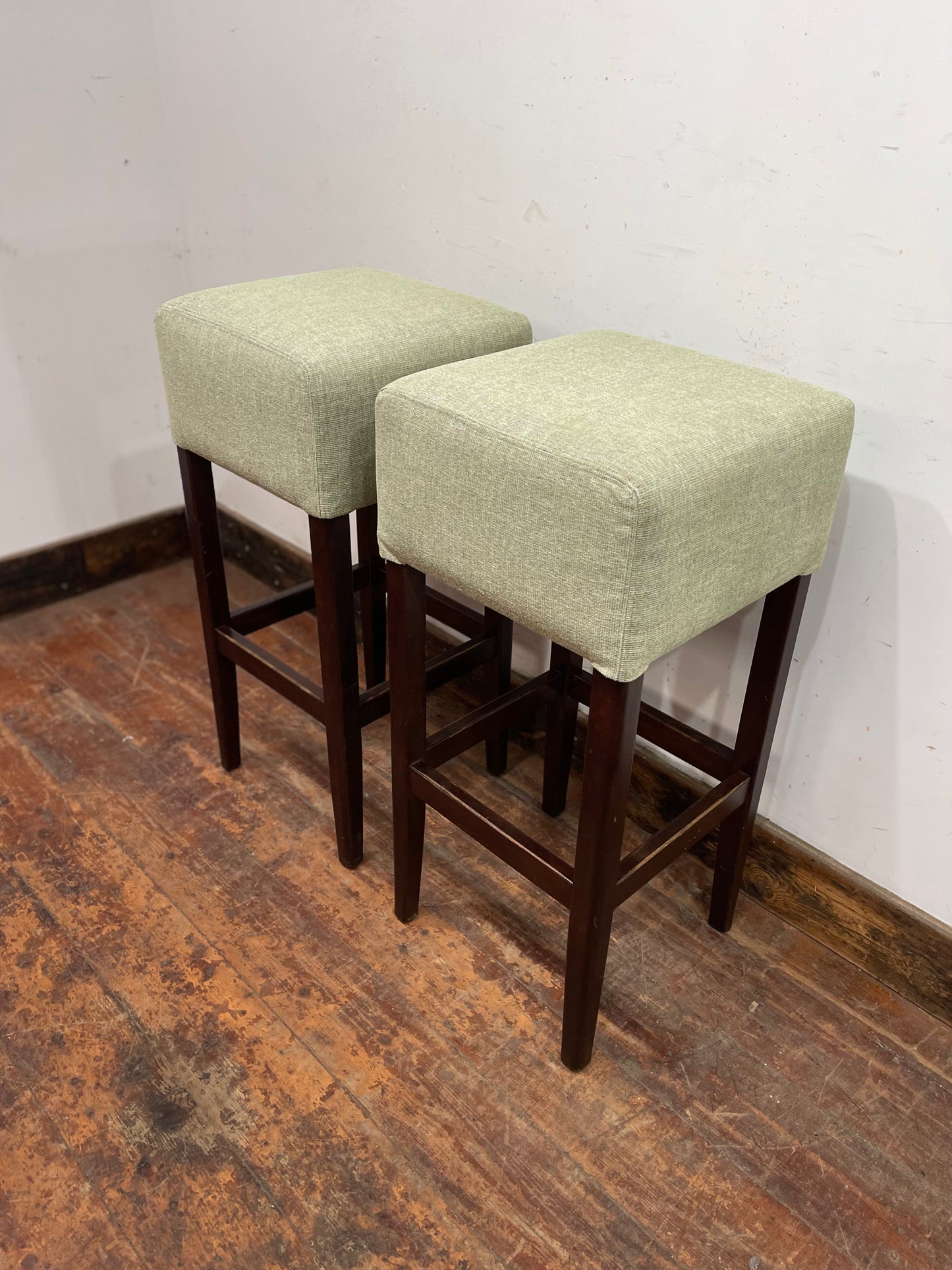 Pair of matching bar stools with light fabric seats