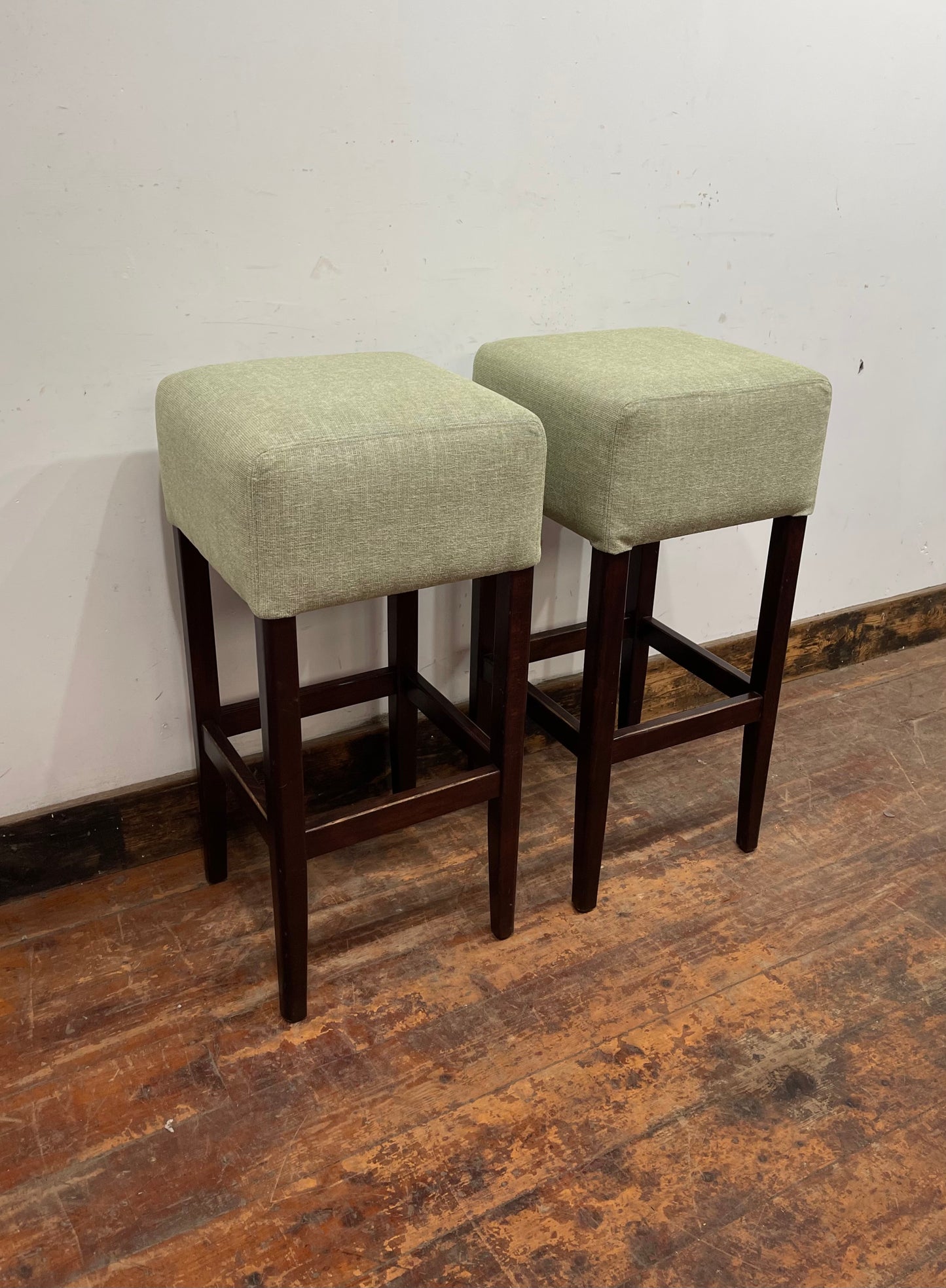 Pair of matching bar stools with light fabric seats