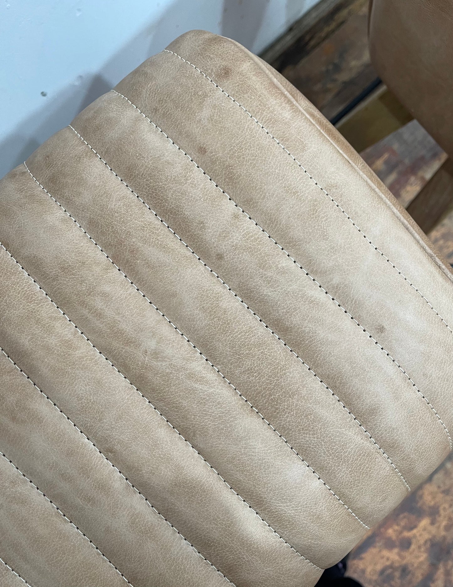 Pair of pommel stools with light tan leather seats