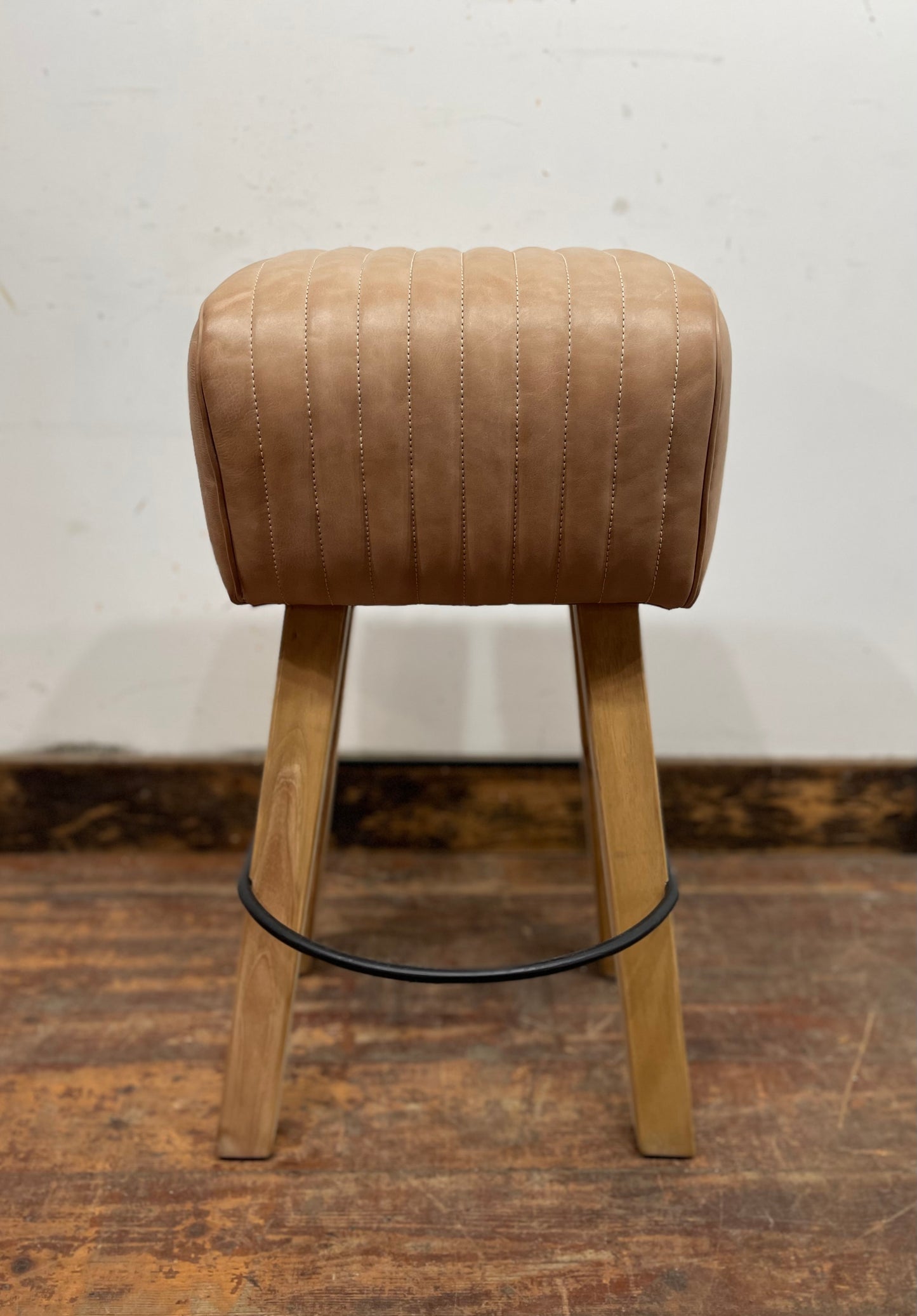 Pommel stool with light tan leather seat