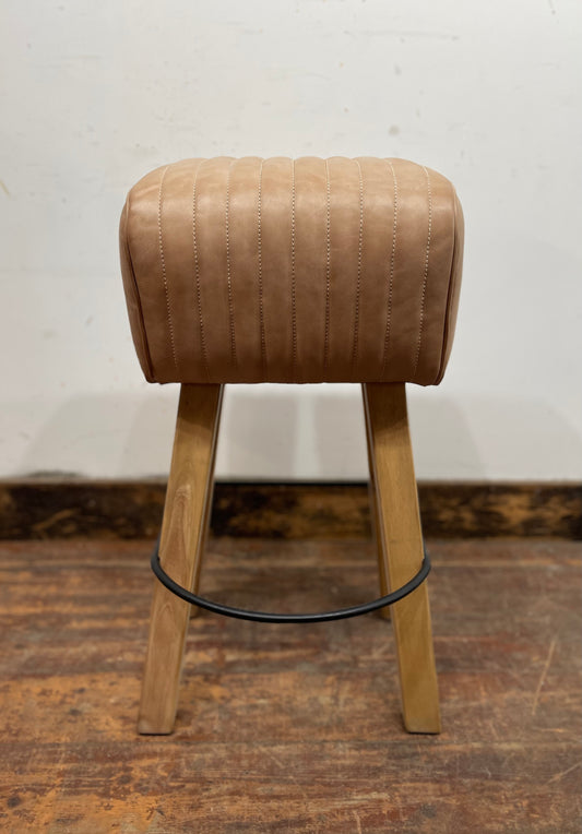Pommel stool with light tan leather seat