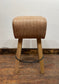 Pommel stool with light tan leather seat