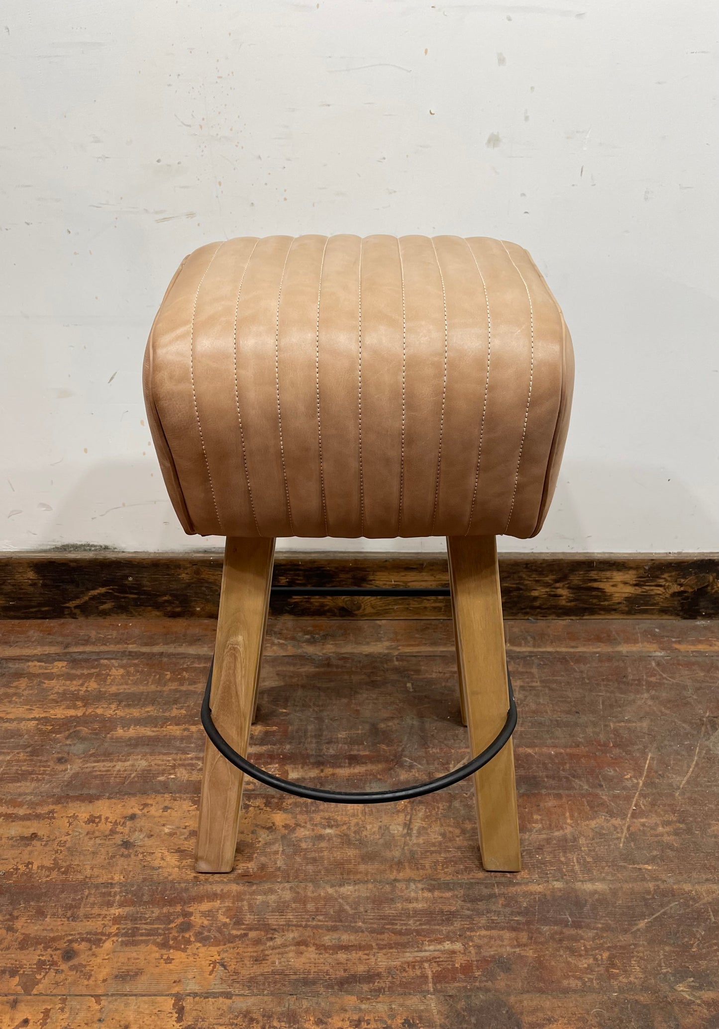 Pommel stool with light tan leather seat
