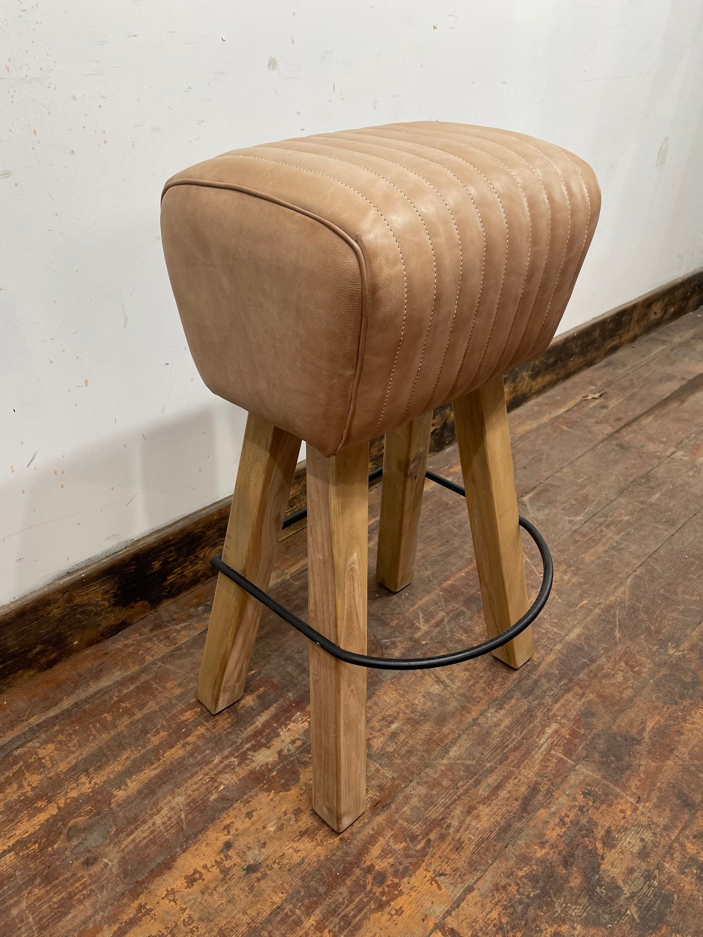 Pommel stool with light tan leather seat