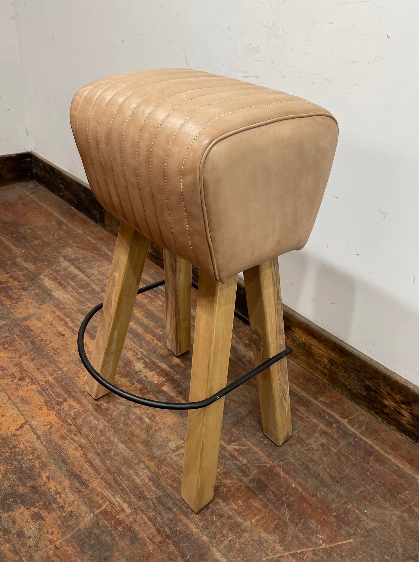 Pommel stool with light tan leather seat