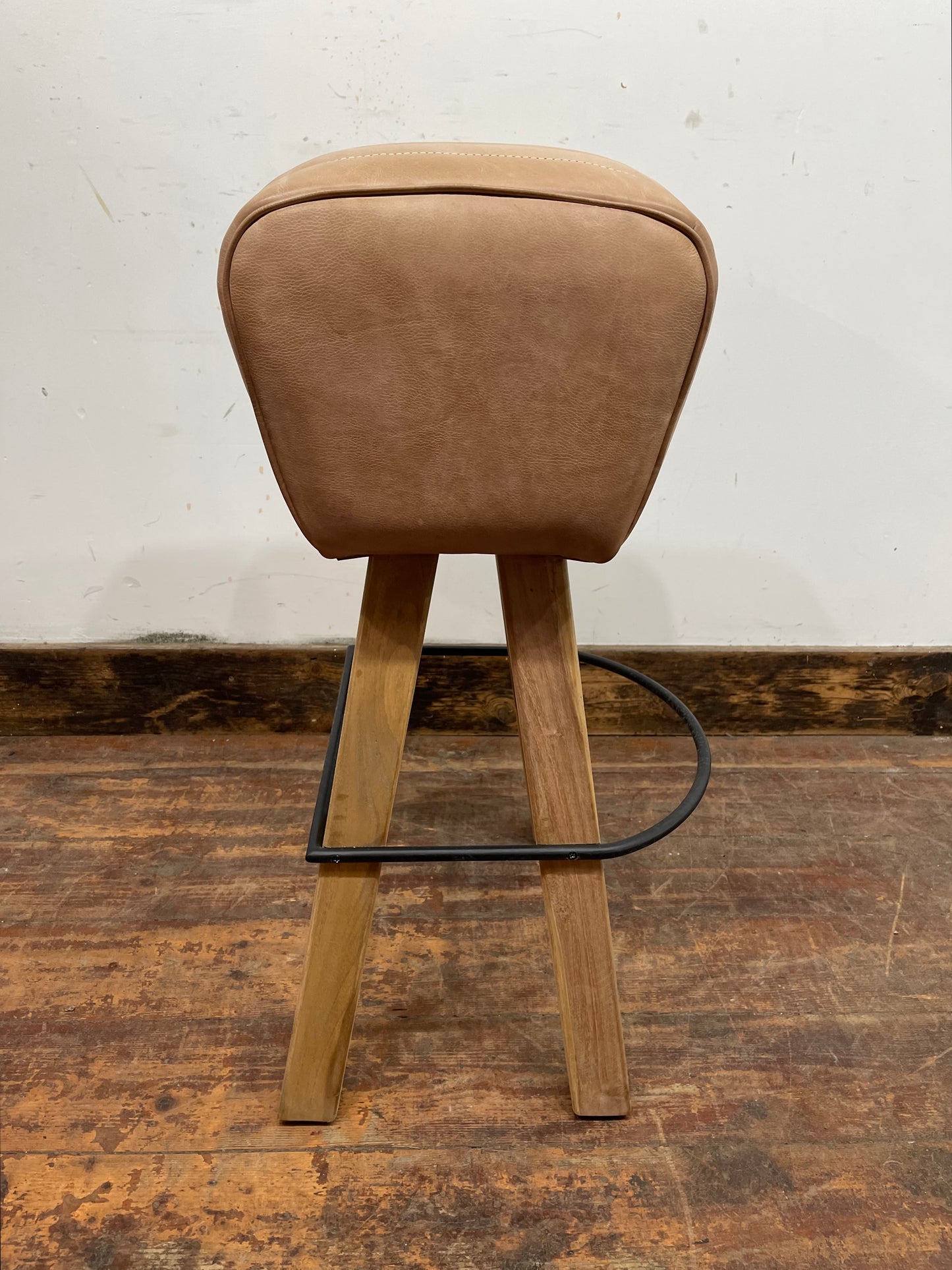 Pommel stool with light tan leather seat