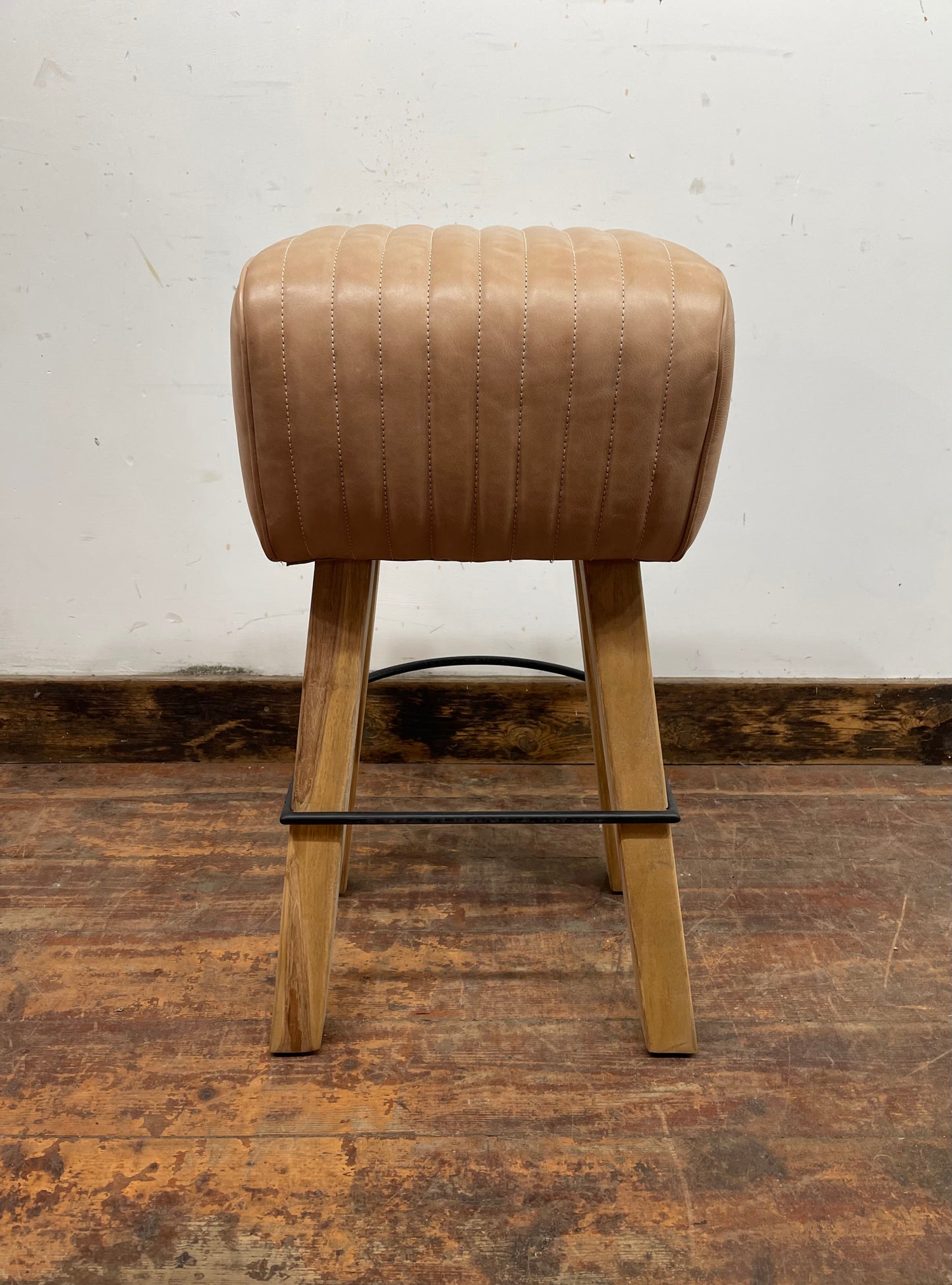 Pommel stool with light tan leather seat