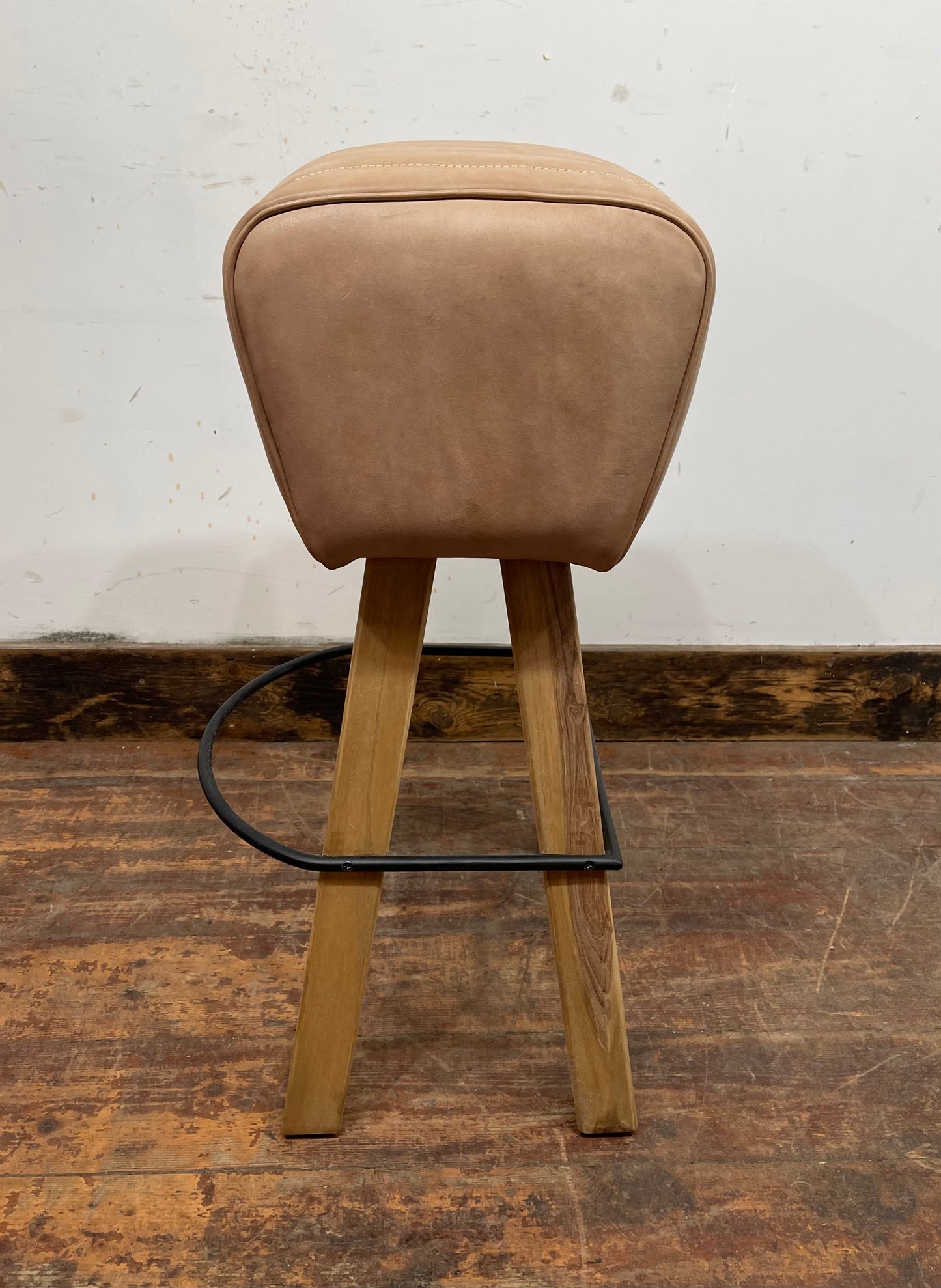 Pommel stool with light tan leather seat