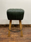 Pommel stool with green leather seat