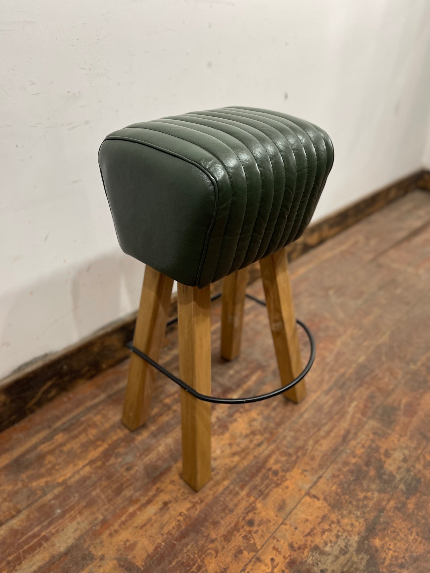 Pommel stool with green leather seat