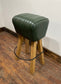 Pommel stool with green leather seat