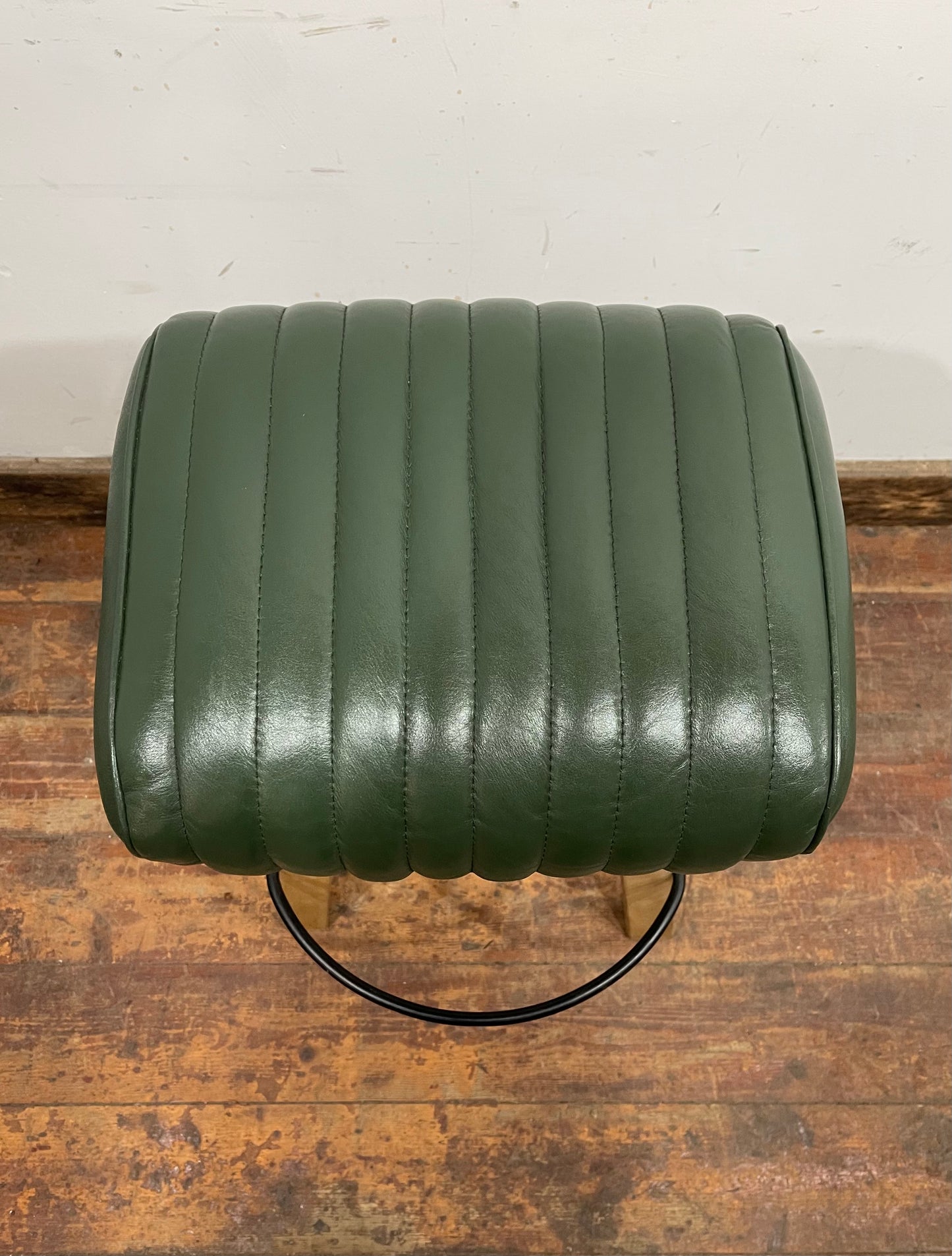 Pommel stool with green leather seat