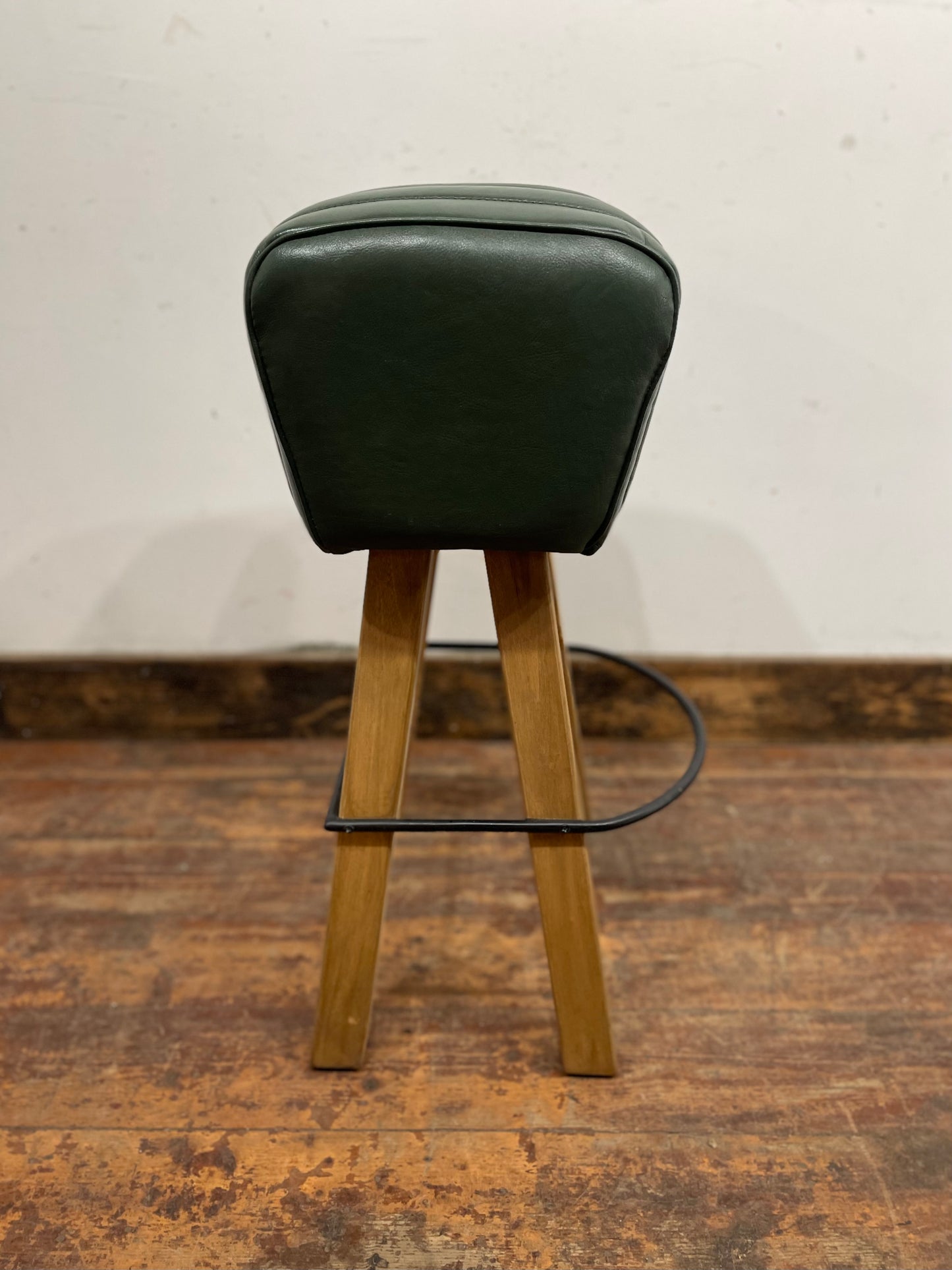 Pommel stool with green leather seat
