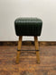 Pommel stool with green leather seat