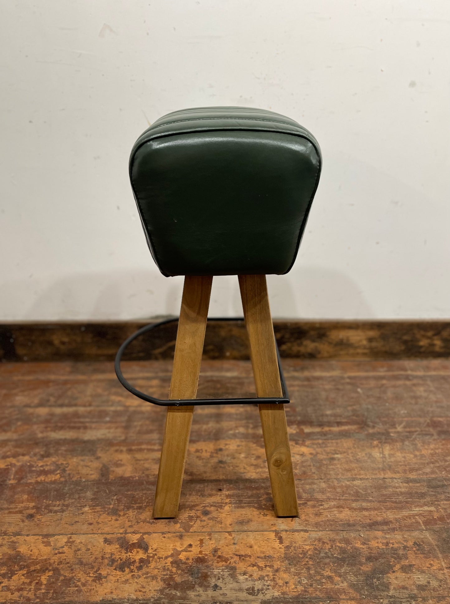 Pommel stool with green leather seat