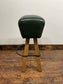 Pommel stool with green leather seat