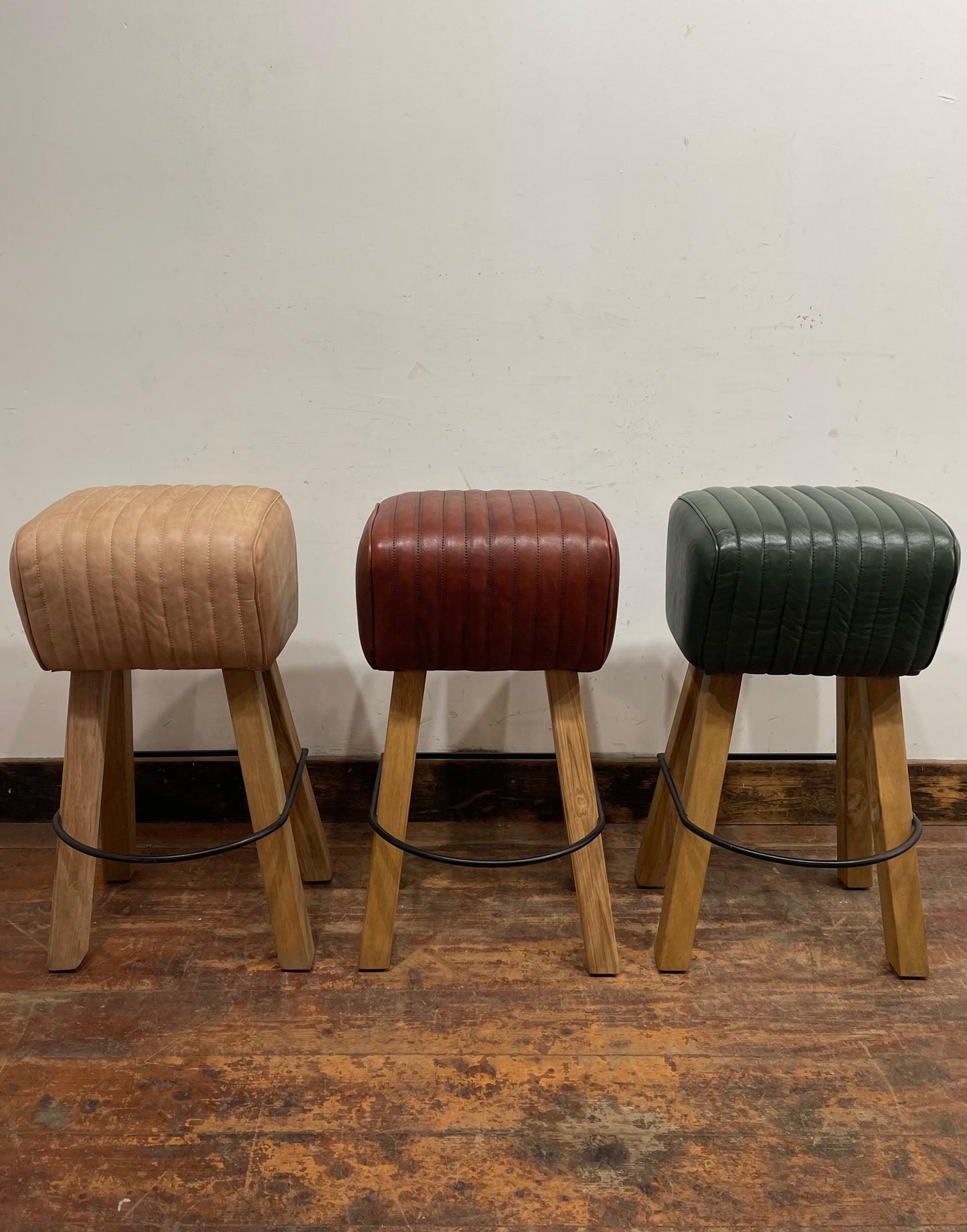 Pommel stool with green leather seat