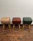 Pommel stool with green leather seat