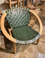 Stylish moon chair with wooden frame and green leather seat