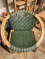 Stylish moon chair with wooden frame and green leather seat