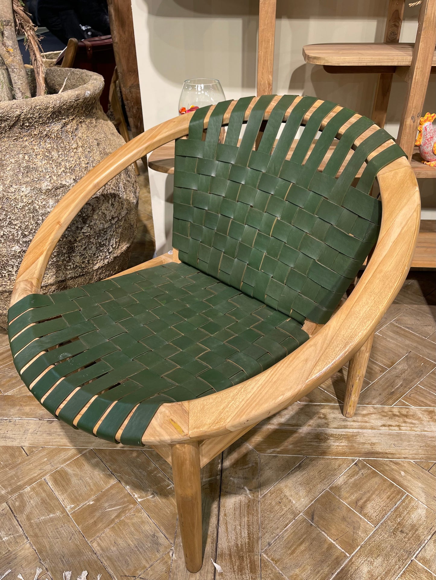 Stylish moon chair with wooden frame and green leather seat